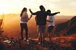 Wise Options For a Good and Happy Life By Tomer Levi Four Person Standing at Top of Grassy Mountain